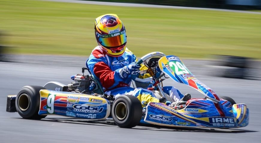 A go-kart racer in a colorful suit and helmet speeds around the racetrack in a blue and yellow kart, number 9 on the side and 29 on the front, during the Karting Championships at Tullyallen Karting Club on 25th October 2020. A go-kart racer in a colorful suit and helmet speeds around the racetrack in a blue and yellow kart, number 9 on the side and 29 on the front, during the Karting Championships at Tullyallen Karting Club on 25th October 2020.